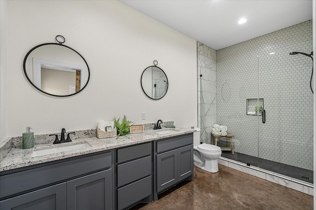 bathroom with toilet, vanity, concrete flooring, and a shower with shower door