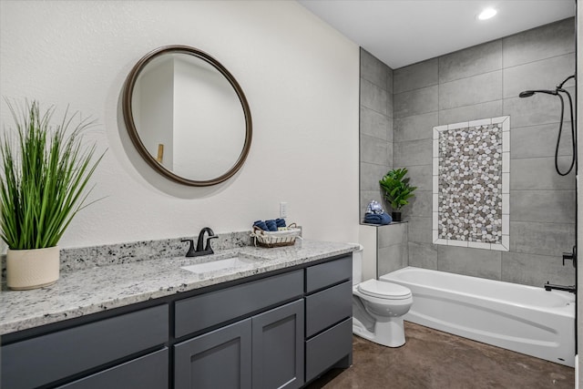 full bathroom featuring tiled shower / bath combo, vanity, and toilet