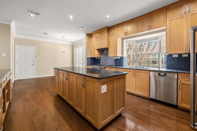 kitchen featuring sink, dishwasher, hanging light fixtures, a center island, and dark hardwood / wood-style flooring