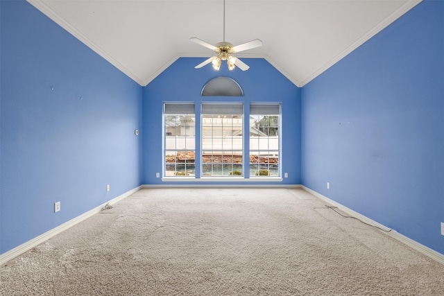 spare room with lofted ceiling, crown molding, ceiling fan, and carpet