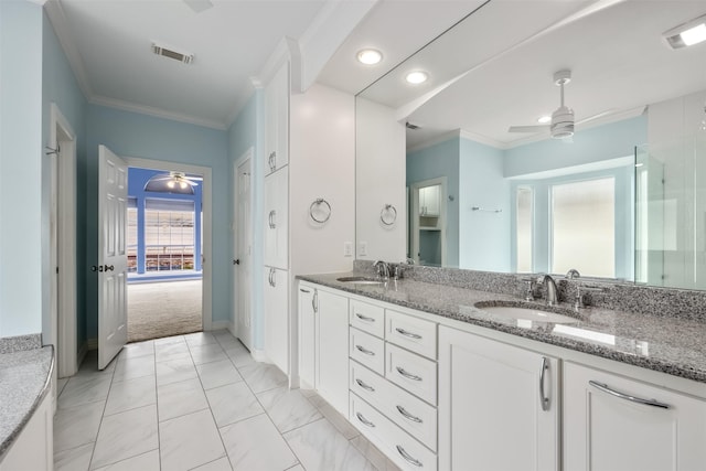 bathroom with crown molding, vanity, and ceiling fan