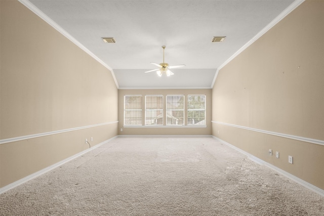 unfurnished room featuring ornamental molding, lofted ceiling, and carpet flooring