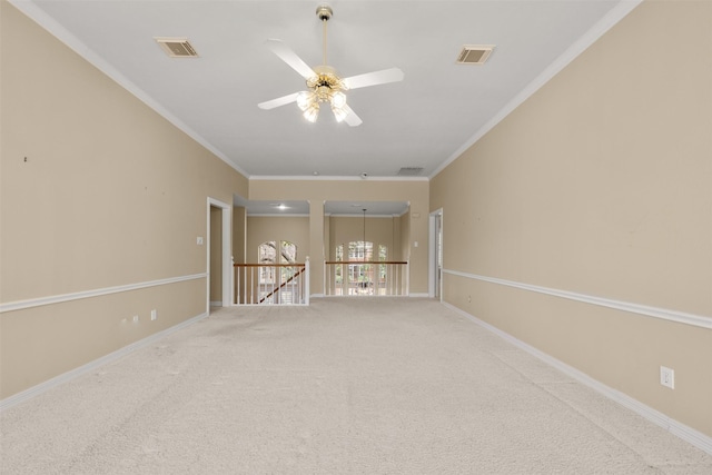 spare room featuring crown molding, carpet flooring, and ceiling fan