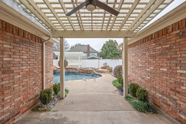 view of patio with a pergola, pool water feature, and an in ground hot tub