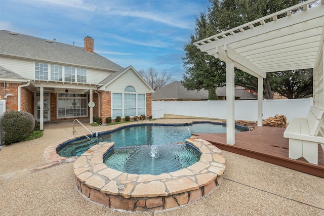 view of swimming pool with a wooden deck, pool water feature, an in ground hot tub, and a pergola