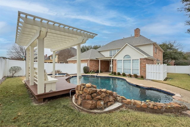 view of pool with a wooden deck, a pergola, and a lawn