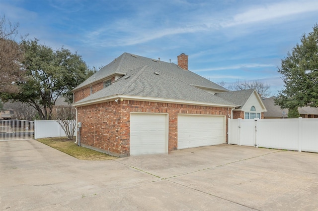 view of side of home with a garage