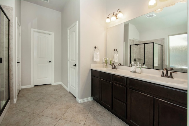 bathroom with vanity, tile patterned floors, and a shower with door