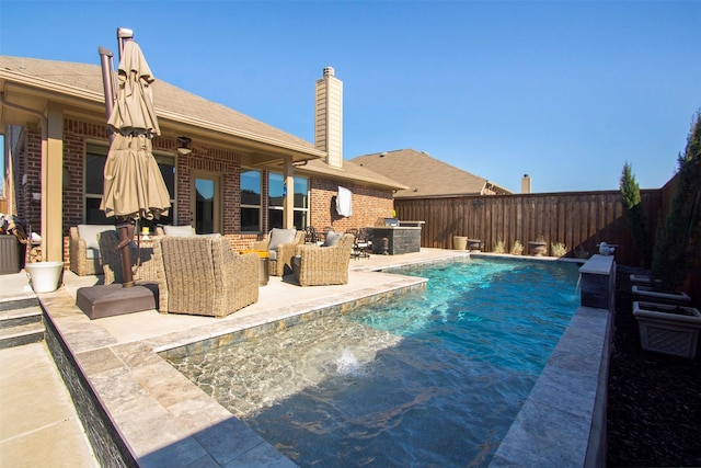 view of pool with pool water feature, area for grilling, an outdoor hangout area, and a patio