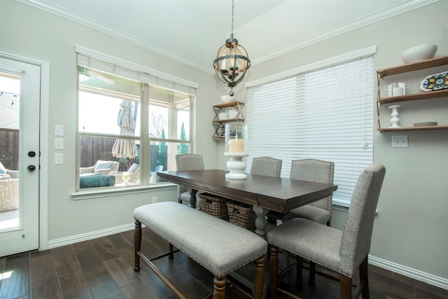 dining room featuring ornamental molding, dark wood-type flooring, and a chandelier