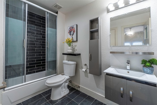 full bathroom featuring tile patterned flooring, vanity, enclosed tub / shower combo, and toilet