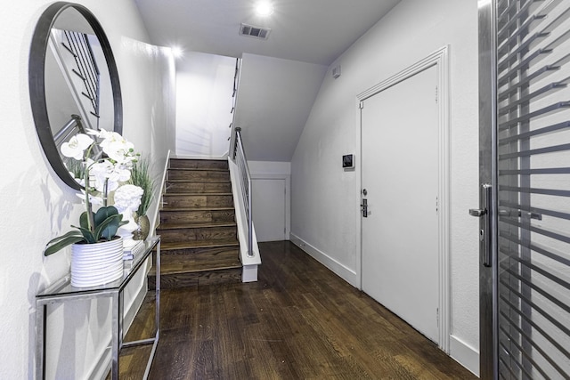 hall featuring lofted ceiling and dark wood-type flooring