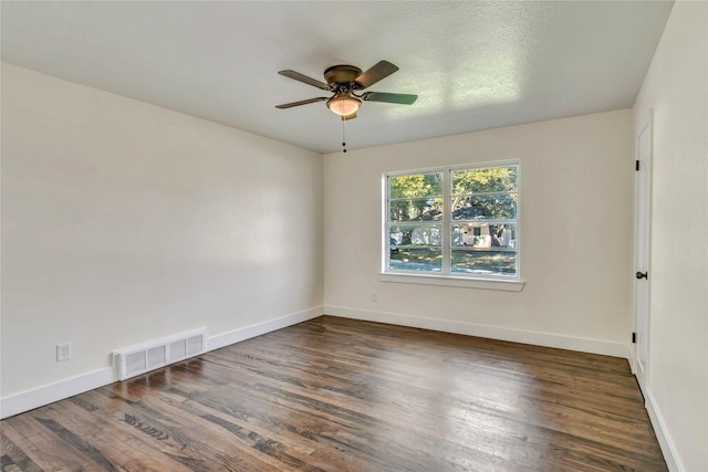 unfurnished room with ceiling fan and dark hardwood / wood-style flooring