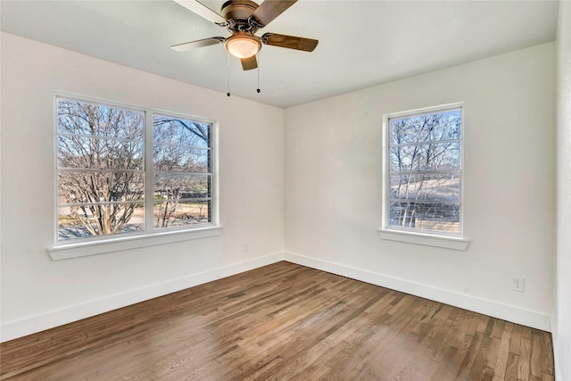 empty room with hardwood / wood-style floors and ceiling fan