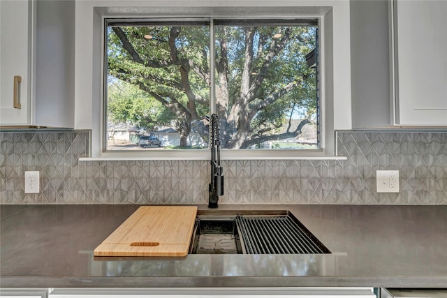 kitchen featuring white cabinetry and decorative backsplash