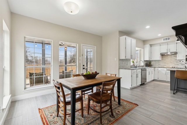 dining area featuring sink and light hardwood / wood-style flooring