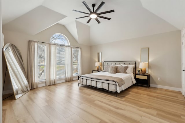 bedroom with vaulted ceiling, light wood finished floors, a ceiling fan, and baseboards