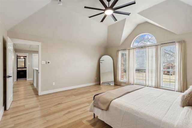 bedroom featuring light wood-style flooring, a ceiling fan, baseboards, vaulted ceiling, and attic access