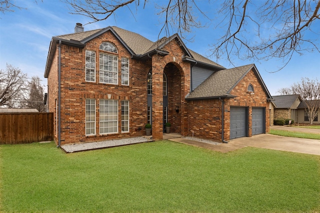 view of front of property featuring a garage and a front lawn