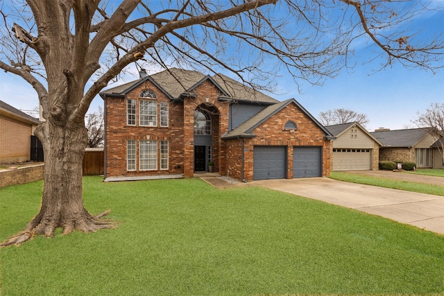 traditional-style home with brick siding, a chimney, concrete driveway, an attached garage, and a front yard