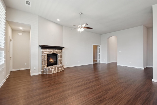 unfurnished living room featuring a ceiling fan, dark wood-style flooring, visible vents, a fireplace, and recessed lighting