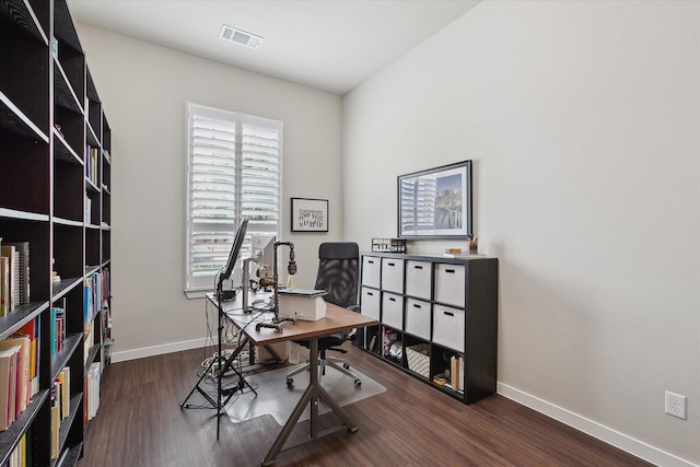 home office with dark wood-type flooring