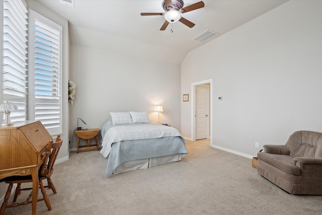 carpeted bedroom with ceiling fan and vaulted ceiling