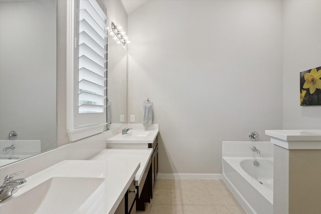 bathroom featuring tile patterned flooring, vanity, and a tub to relax in