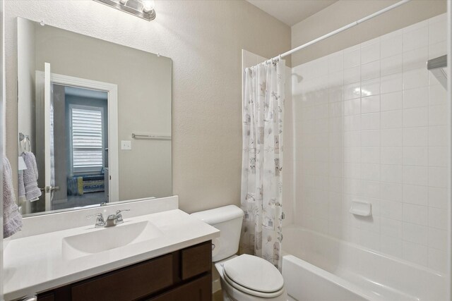 full bath featuring vanity, toilet, and shower / tub combo with curtain