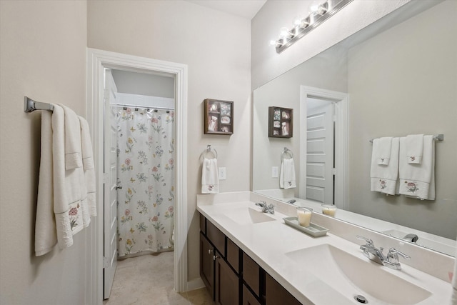full bath featuring double vanity, a shower with curtain, and a sink