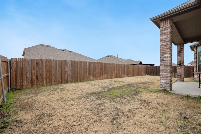 view of yard with a patio and a fenced backyard
