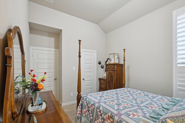 carpeted bedroom featuring lofted ceiling