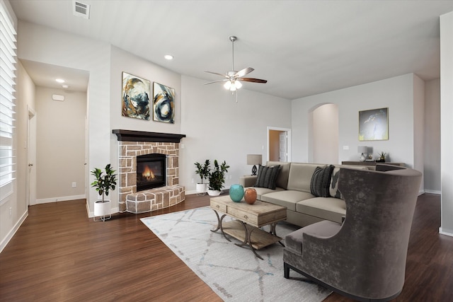 living room with arched walkways, ceiling fan, visible vents, and wood finished floors