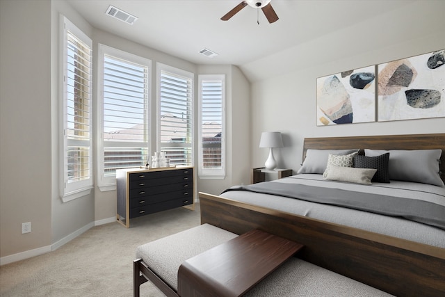 bedroom with baseboards, ceiling fan, light colored carpet, and visible vents