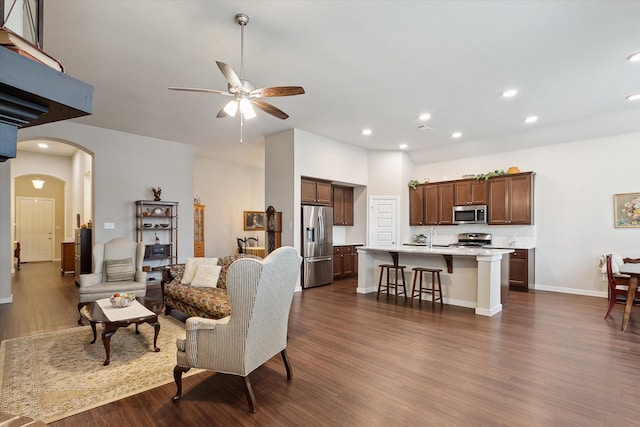 living room with ceiling fan, dark hardwood / wood-style floors, and sink