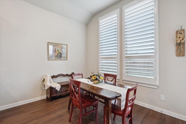 dining room featuring dark hardwood / wood-style flooring and vaulted ceiling