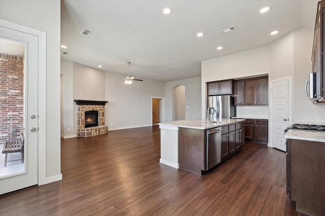 kitchen with dark brown cabinetry, a ceiling fan, open floor plan, visible vents, and dark wood-style floors