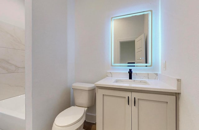 bathroom featuring vanity and toilet