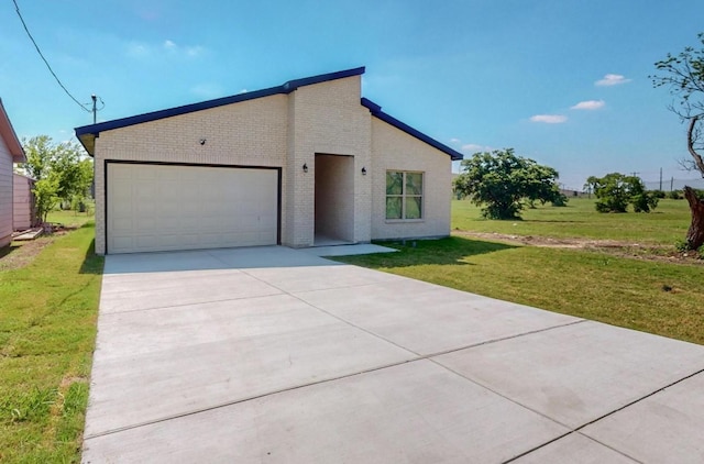 view of front of property with a garage and a front lawn