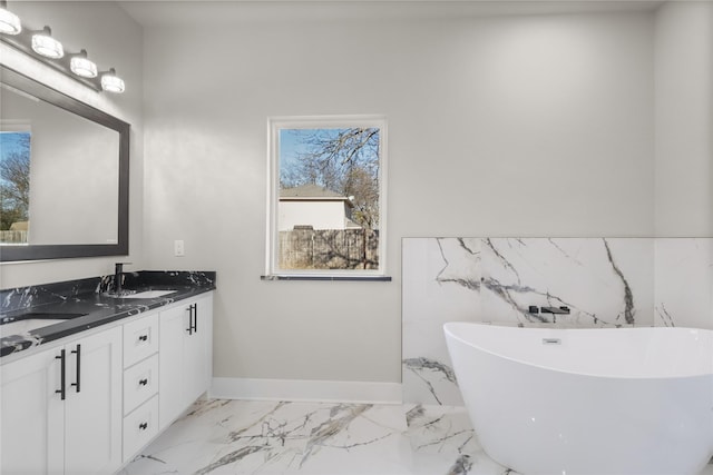 bathroom featuring vanity and a washtub