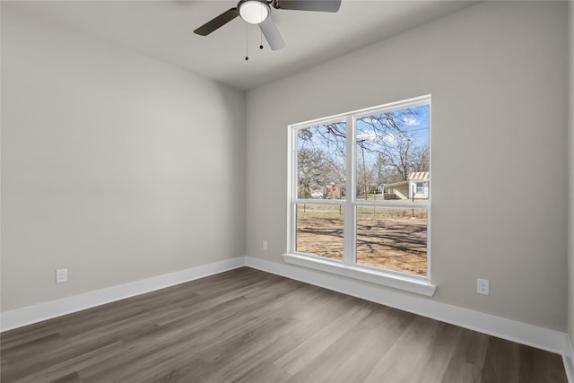 empty room with ceiling fan and hardwood / wood-style floors