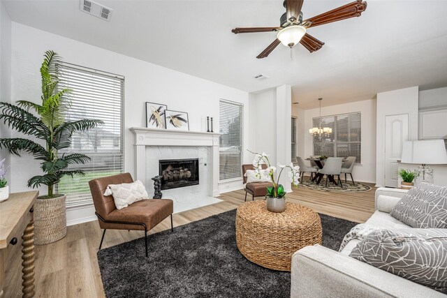 living room with sink, ceiling fan, and light wood-type flooring