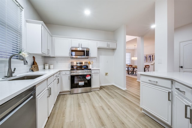 kitchen with white cabinetry, appliances with stainless steel finishes, and sink