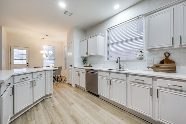 kitchen featuring sink, white cabinetry, hanging light fixtures, light hardwood / wood-style flooring, and dishwasher