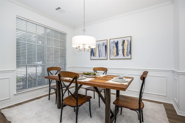 dining area featuring ornamental molding and dark hardwood / wood-style floors