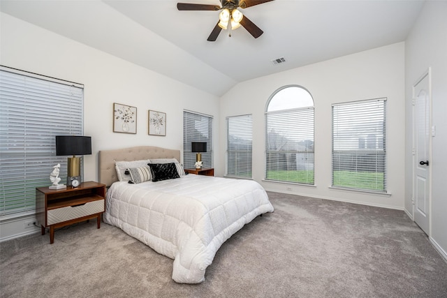 carpeted bedroom with vaulted ceiling and ceiling fan