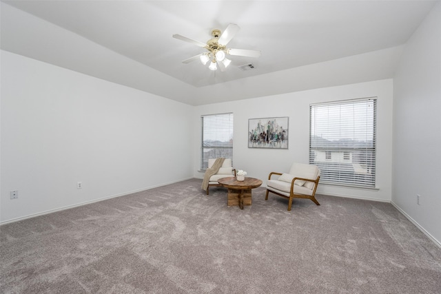 unfurnished room featuring ceiling fan, a raised ceiling, and light colored carpet