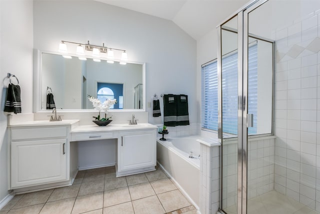 bathroom with tile patterned flooring, vanity, lofted ceiling, and independent shower and bath