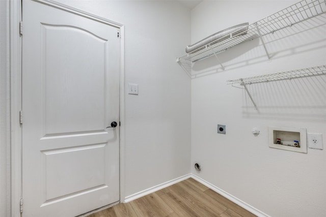 washroom with hookup for a washing machine, gas dryer hookup, electric dryer hookup, and light hardwood / wood-style flooring