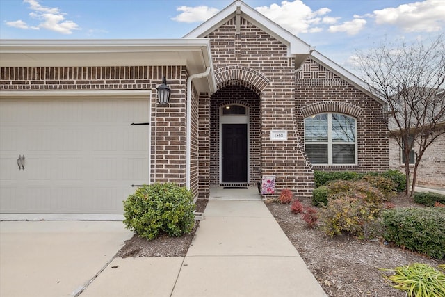 view of front of house with concrete driveway, brick siding, and an attached garage